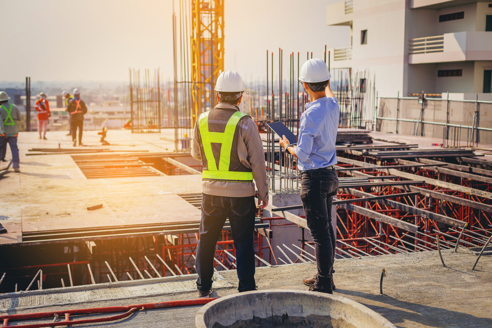 Construction engineers on site reviewing rebar work